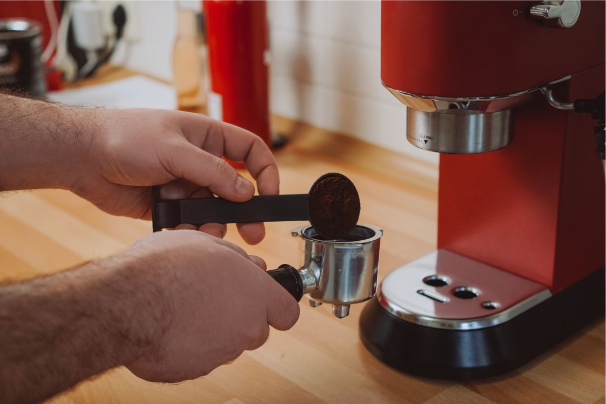 Hands using espresso machine