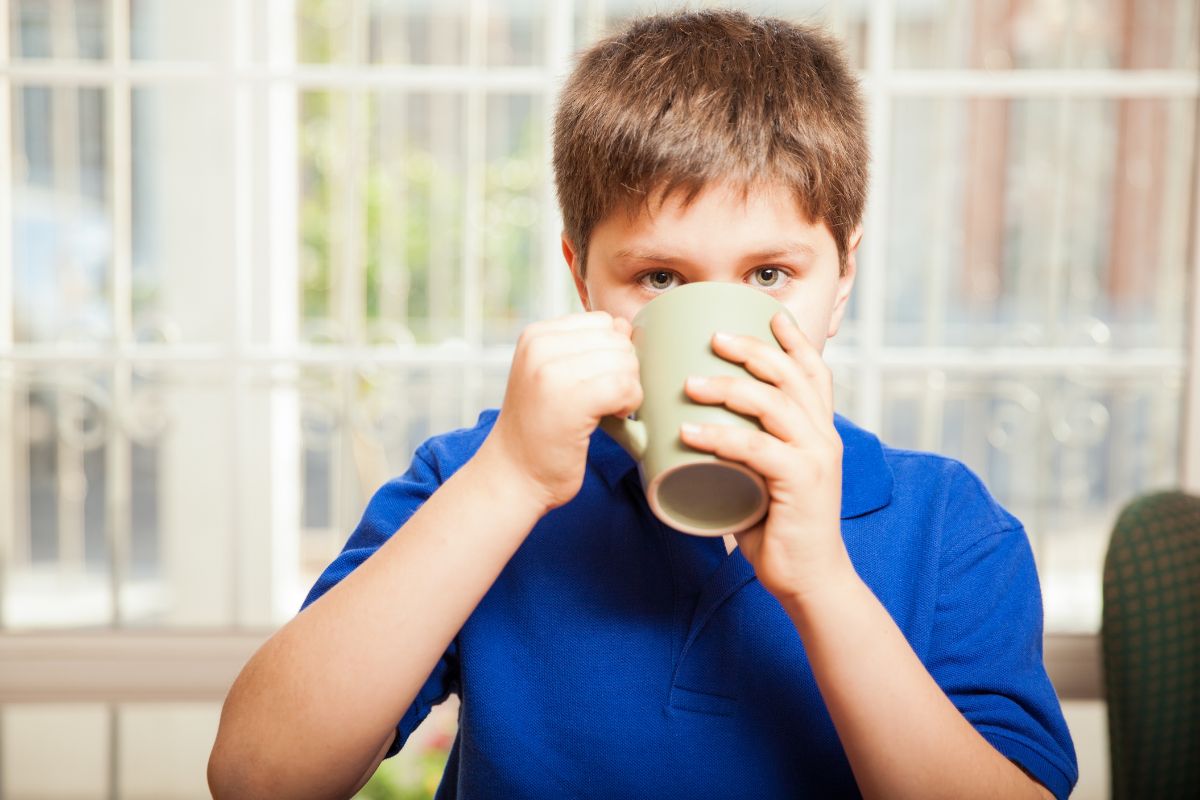Young boy drinking coffee