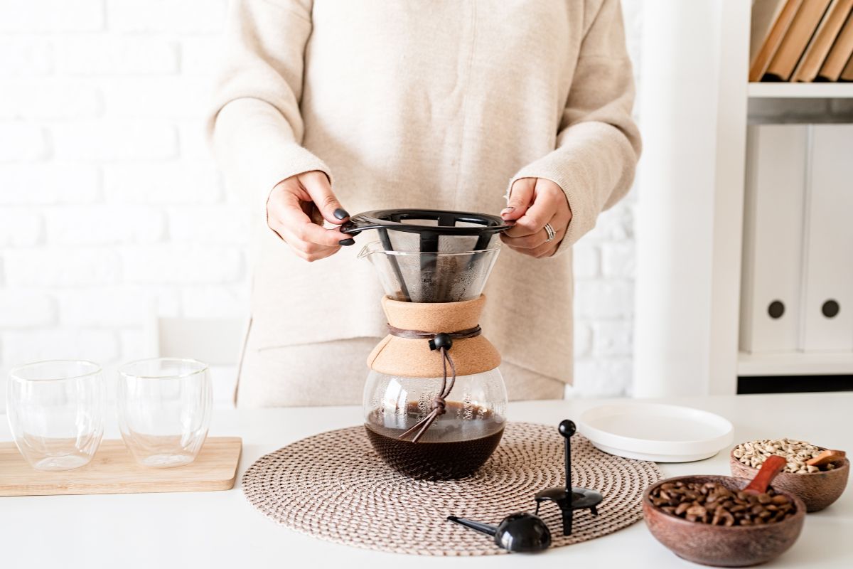 Young woman brewing coffee in chemex