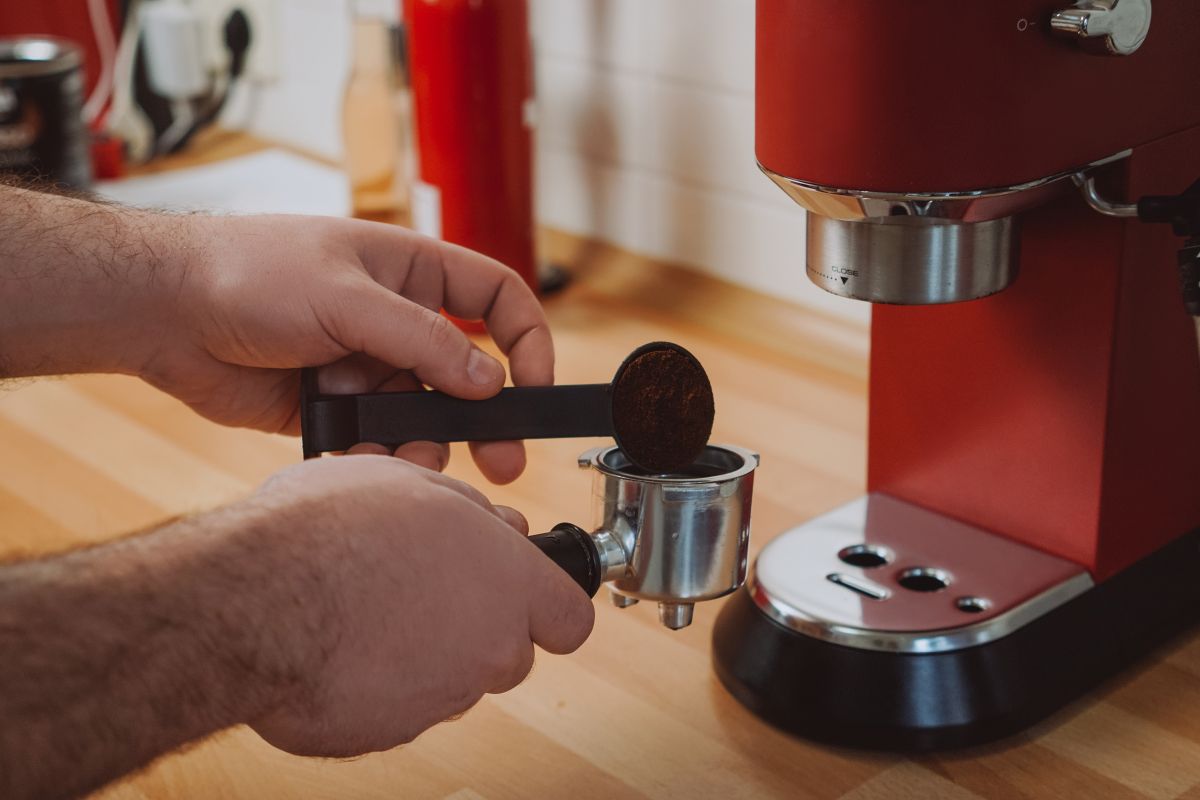 Hands using espresso machine