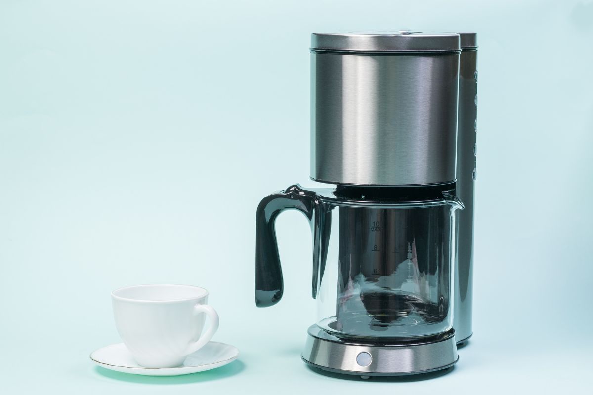 white coffee cup and drip coffee maker